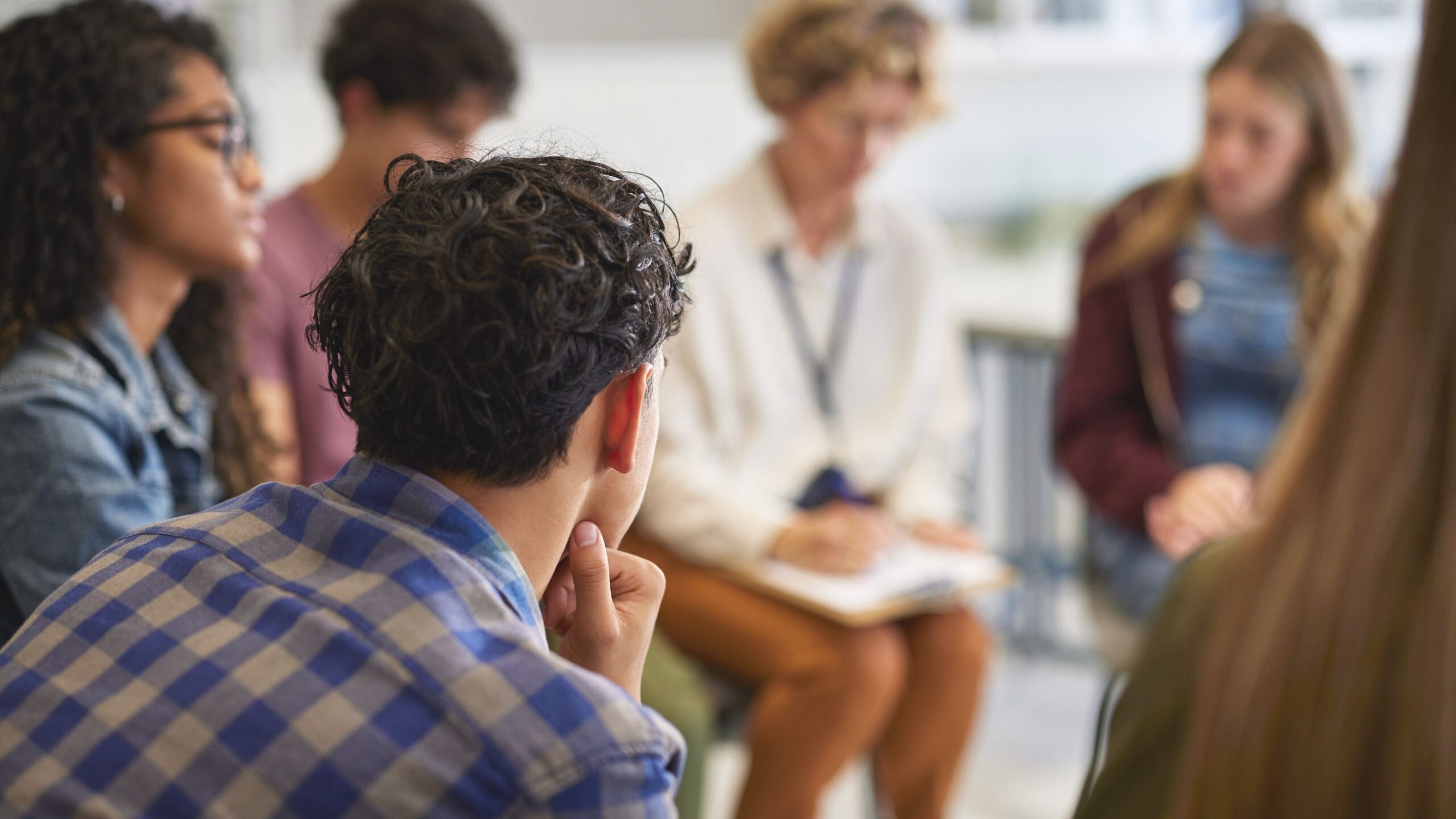 Several people are sitting in a circle discussing.