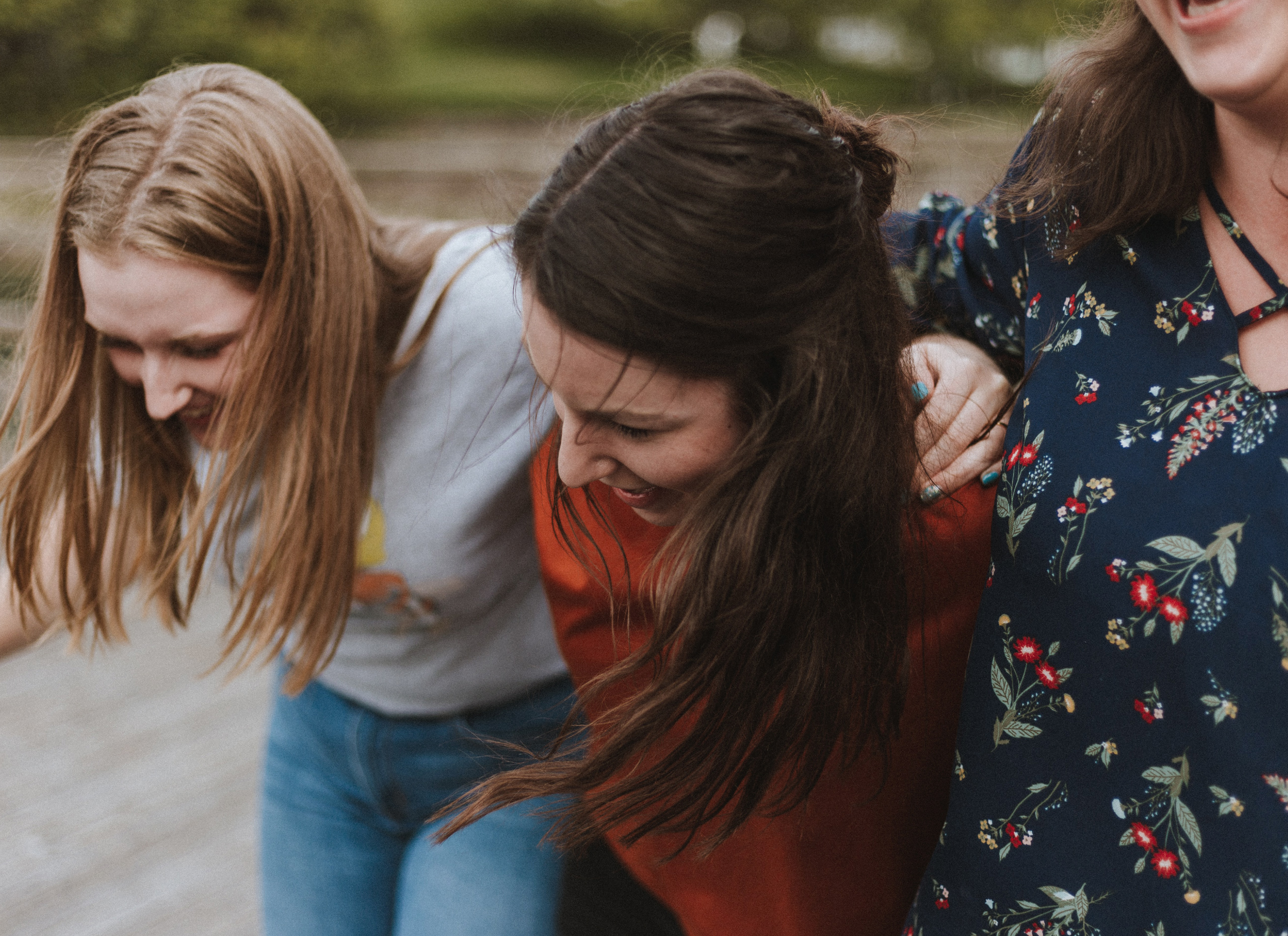 Three women walking and laughing.