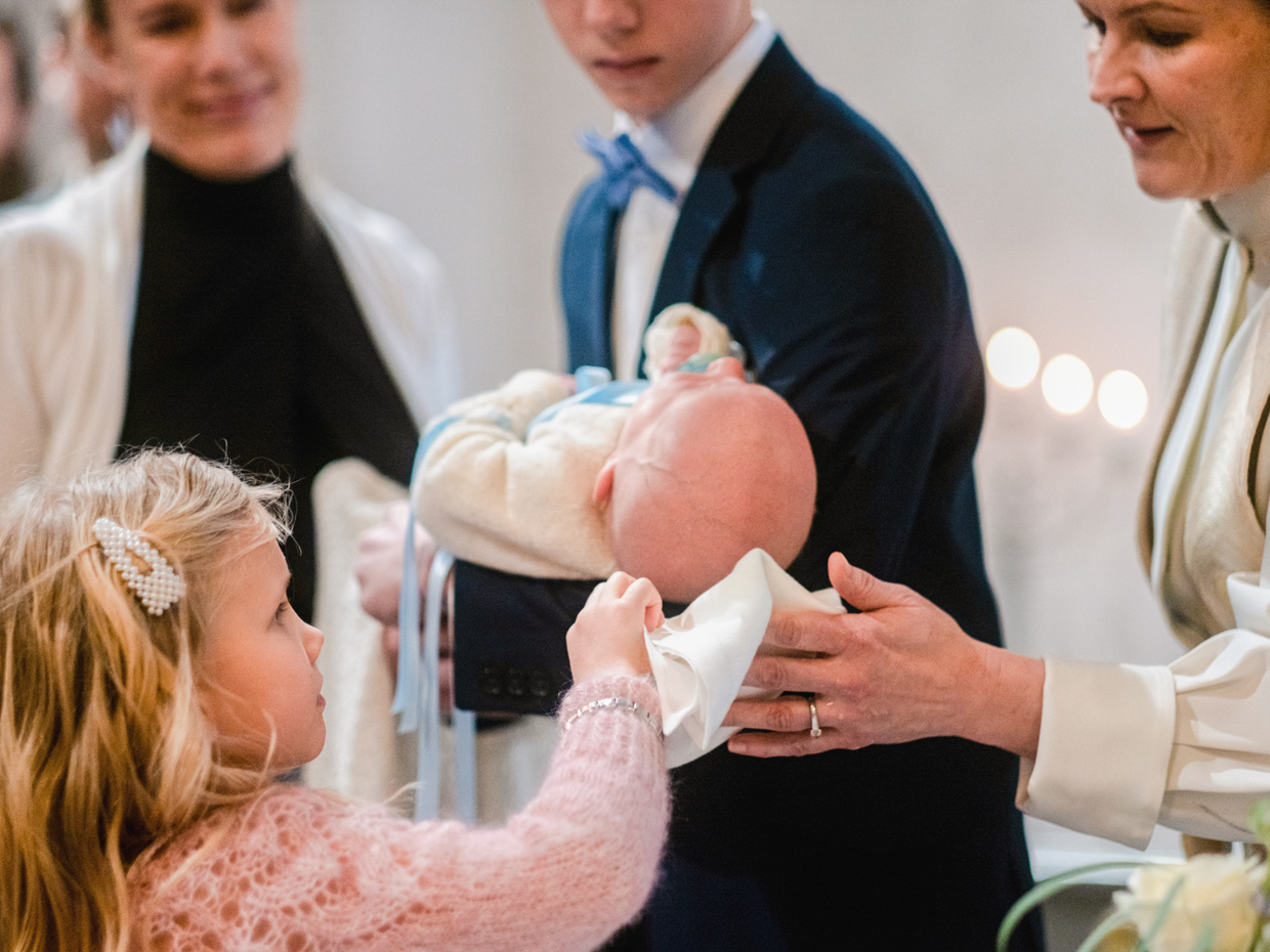 A pastor baptises a child.